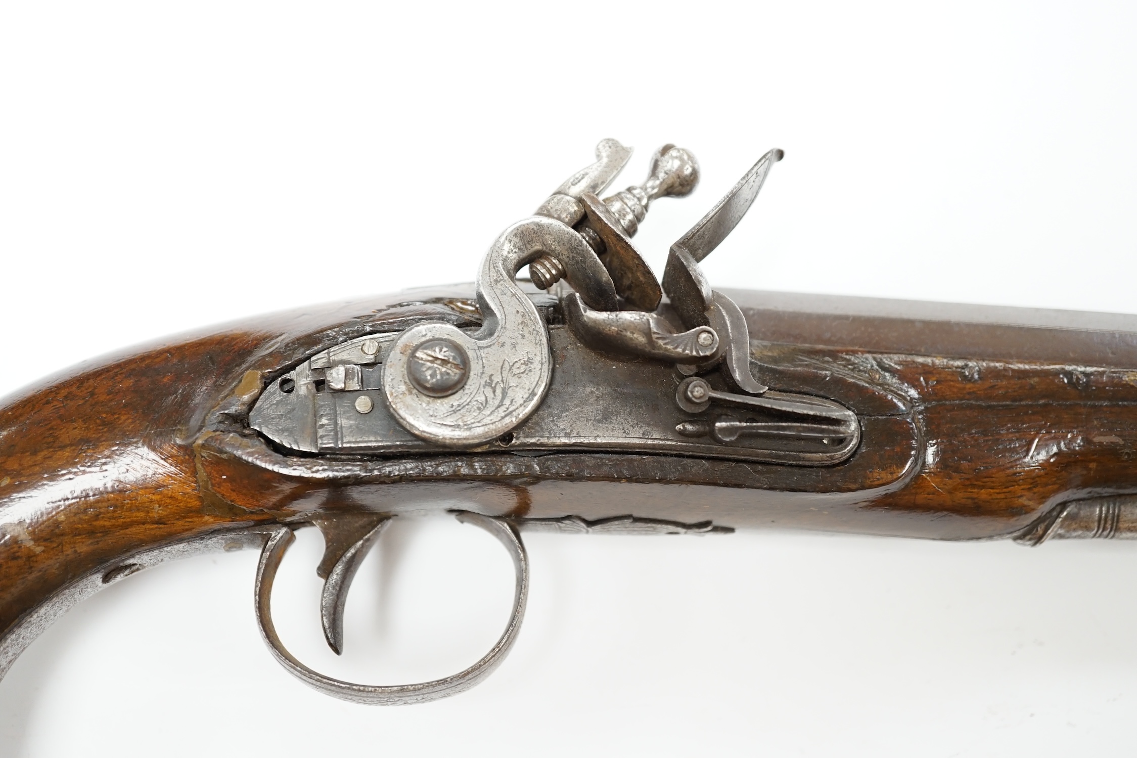 An early 19th century 12 bore fully stocked flintlock holster pistol, octagonal barrel with Birmingham proof marks, engraved iron trigger guard, iron tipped wooden ramrod, barrel 15.5cm. Condition - fair, cock replaced,